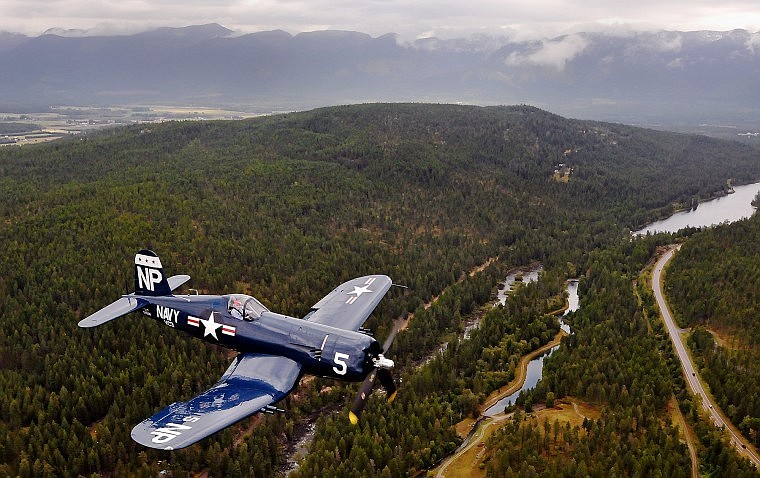 A Corsair plane piloted by Steve Bakke flies over Montana Highway 209.