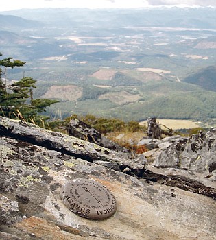 &lt;p&gt;Benchmarks containing an arrow are reference marks that point to a horizontal control point marking a precise latitude and longitude. This benchmark references the Goat Mountain Lookout, which was a benchmark before it was destroyed.&lt;/p&gt;