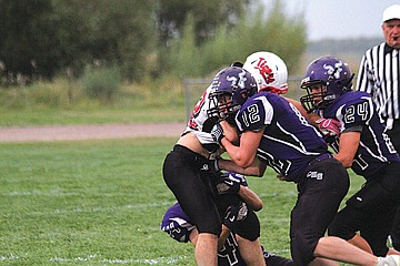 &lt;p class=&quot;p1&quot;&gt;Dusty Berkram (12), Kyle Couture (24) and Jesse Long gang tackle a Darby running back in Friday night&#146;s 59-28 victory.&lt;/p&gt;