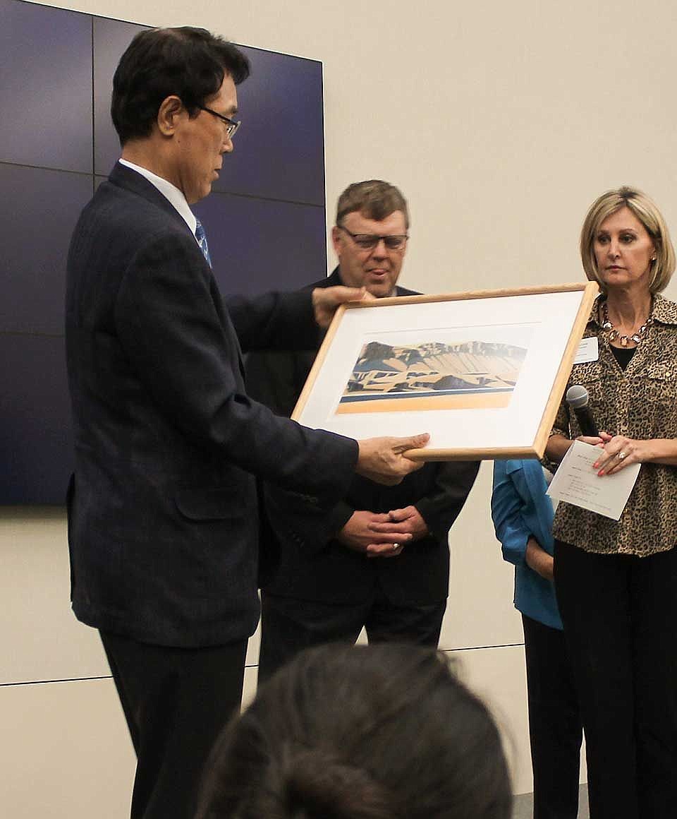 Kim Yoon Joo, mayor of Gunpo City, Korea admires his gift from the Grant County Economic Development Council on Tuesday at the Columbia Basin Trade Expo &amp; Dinner.