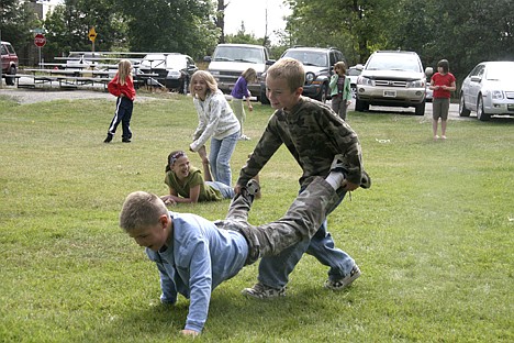 &lt;p&gt;Seven-year-old Steele Hammond (left) and Ethan Hull, 8, participate in a wheelbarrow race during Labor Day on the Grass in Spirit Lake.&lt;/p&gt;