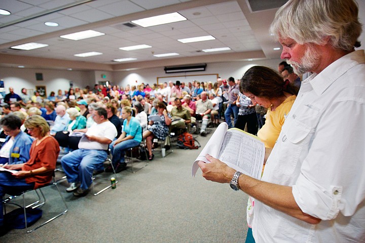 &lt;p&gt;JEROME A. POLLOS/Press Brian Carlstad reviews the Kootenai County financial budget for 2012 during a public hearing Tuesday in the county administration building.&lt;/p&gt;