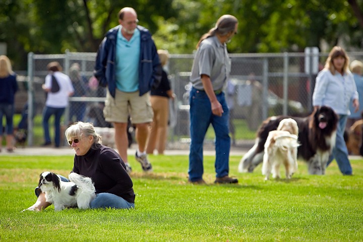 &lt;p&gt;Charmaine Caraway sits in the grass of the Central Bark dog park Monday before letting off her leash to play during the grand opening celebration of the Coeur d'Alene park.&lt;/p&gt;