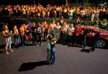 <p>Antonio Wilburn and Dacia Cheyney, parents of Maliki Wilburn, embrace in front of more than 125 people Monday evening at Crowley Park in Spokane as they mourn the death of their 17-month-old boy.</p>