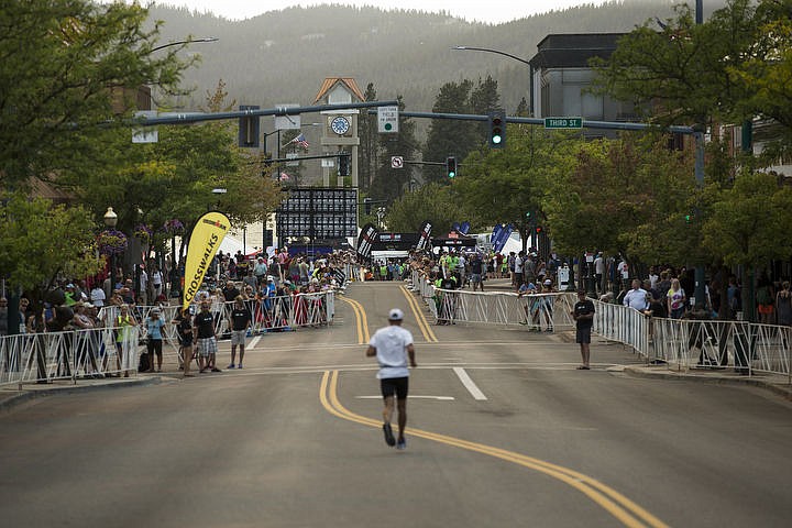 &lt;p&gt;A runner makes his way down Sherman Avenue to the finish line of Ironman Coeur d'Alene on Sunday under smoke a smoke filled sky.&lt;/p&gt;