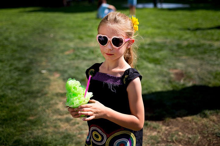 &lt;p&gt;Evie Rau, 7, holds a lime-flavored shaved ice treat on Friday at Taste of Coeur d'Alene in City Park.&lt;/p&gt;