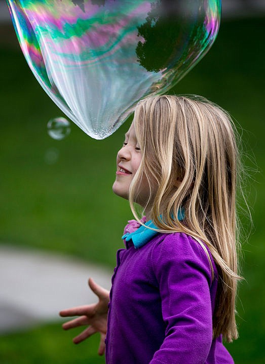 &lt;p&gt;Naomi Kanges, 7, smiles as a giant bubble is about to burst over her head on Wednesday at City Park.&lt;/p&gt;