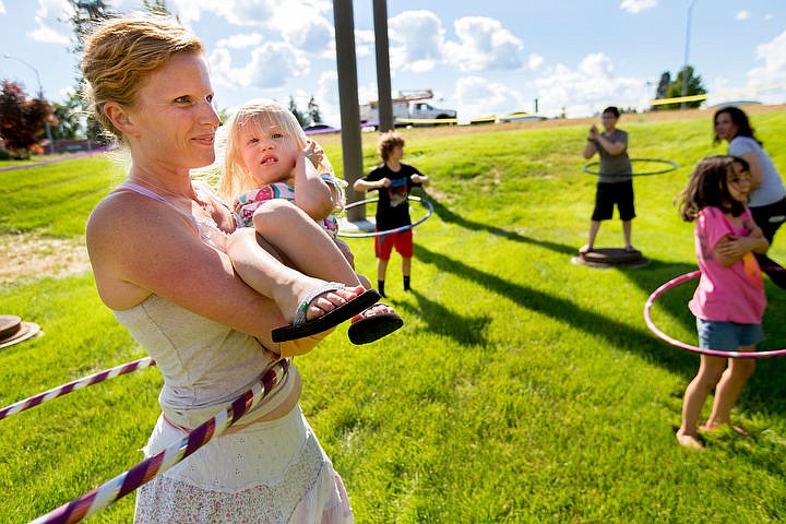 &lt;p&gt;Stephanie Hall holds her 2-year-old daughter Sophia as she hula hoops with 15 others on Thursday at Natural Grocers while attempting to break the world record for most people hula-hooping at the same time for two minutes. More than 120 Natural Grocers locations participated in the attempt as it was live-streamed on Facebook. The current record is 4,700 people.&lt;/p&gt;