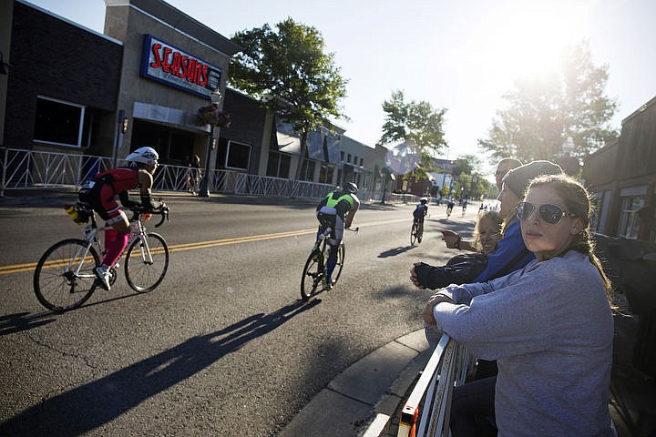 &lt;p&gt;Kelsey O'Haver watches bikers wiz by Seasons of Coeur d'Alene during Ironman Coeur d'Alene on Sunday.&lt;/p&gt;