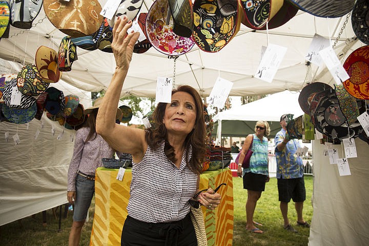 &lt;p&gt;Norine Cowell views Rodi Sheet Ludlum's fabric pottery art, Friday, at Art on the Green 2016.&lt;/p&gt;