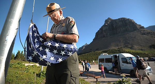 &lt;p&gt;Park ranger Bill Schustrom raises the U.S. flag on Sunday
morning at Logan Pass in Glacier National Park.&lt;/p&gt;