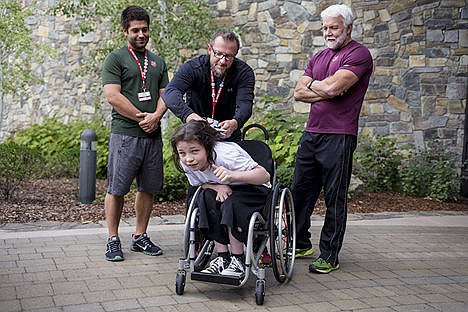 &lt;p&gt;Justin McGlynn, 12, has more than six inches of his hair cut off by his trainer of four years Kevin Nelson, center, as trainers Sean Andrews, left, and Dale Eller watch on Thursday at The Salvation Army Kroc Center. McGlynn, who has cerebral palsy, is donating his hair to the non-profit Locks of Love in hopes of inspiring others to do the same.&lt;/p&gt;