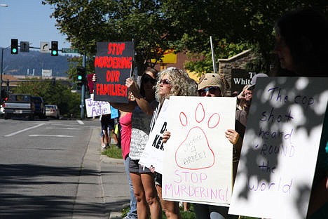 &lt;p&gt;Demonstrators hold signs and wave to passing cars during the Justice for Arfee Rally on Sherman Avenue on Sunday.&lt;/p&gt;