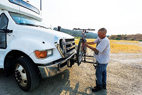 &lt;p&gt;Paul Devore mounts his bike on the front bike rack of a Citylink bus.&lt;/p&gt;