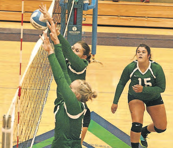 Big Bend College freshmen Maddy Powers, near, and Sierra Schutte go up for the block during Wednesday night&#146;s Northwest Athletic Conference match against Wenatchee Valley College.The Knights won the season opener in three games.