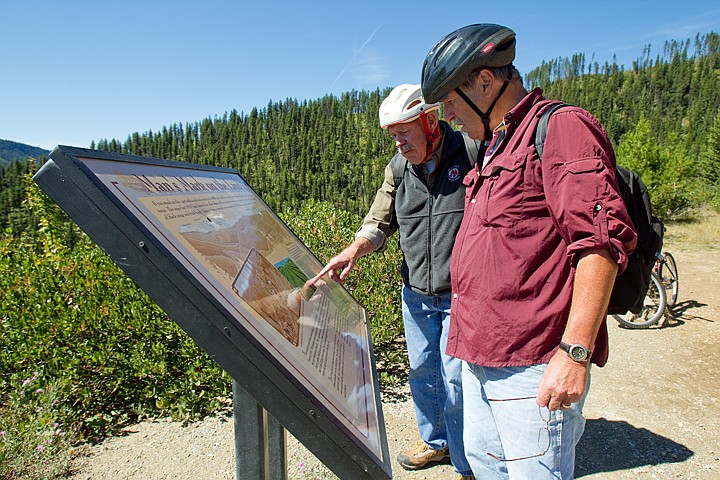 &lt;p&gt;Peter Luttropp, right, and George Evjen, both of Coeur d'Alene, read one of more than two dozen interpretive signs along the Route of the Hiawatha last Thursday during the duo's first trip on the trail.&lt;/p&gt;