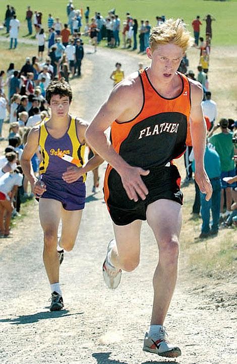 Flathead&#146;s Seth Svennungsen takes the lead midway through the Flathead Invitational boys&#146; varsity cross country race Saturday at Kidsports Complex. Trailing closely behind him is Polson&#146;s Logan Torgison. Svennungsen won the race in a tight finish with Missoula Hellgate&#146;s Jake Roske. Both runners were timed in 16 minutes, 14 seconds.Karen Nichols/Daily Inter Lake