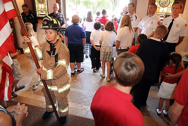 &lt;p&gt;Ferndale Volunteer Firefighter Carolyn Kovacevic holds the
American Flag as parishoners process out of Saint Matthew's
Catholic Church on Friday morning in Kalispell. Kovacevic led a
procession of students, staff and family members from the church to
the Kalispell Fire Department carrying 343 flags in honor of the
first responders who died in the 9/11 terrorist attacks.&lt;/p&gt;