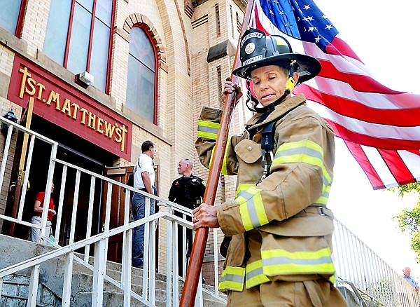 &lt;p&gt;Ferndale volunteer firefighter Carolyn Kovacevic carries the
flag out of St. Matthew&#146;s Church on Friday morning. Kovacevic led a
procession of students, staff and family members carrying 343 flags
in honor of the first responders who died in the 9/11 terrorist
attacks.&lt;/p&gt;