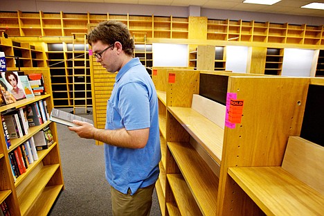 &lt;p&gt;Timothy J. Morgan browses the remaining selection of books offered at up to 90 percent discounts at Borders in Coeur d'Alene.&lt;/p&gt;