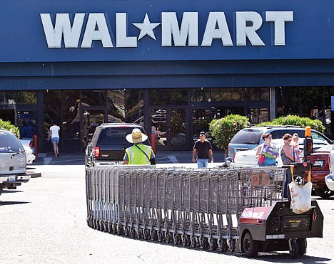 &lt;p&gt;A Wal-Mart worker pulls carts at a Wal-Mart store in Pittsburg, Calif., on June 20. Wal-Mart's second-quarter profit rose 5.7 percent, fueled by strong international sales and expense cutting.&lt;/p&gt;