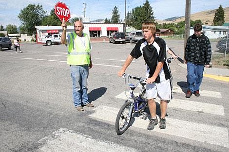 Jason Shueh/Valley Press Bill Beck leads kids across the schools crosswalk, making sure they wait for three blows of his whistle before they cross the street.