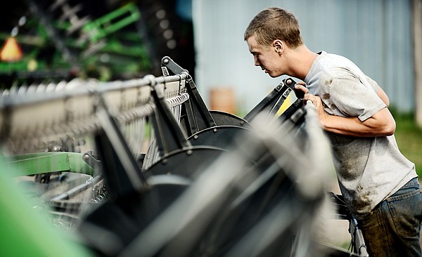 &lt;p&gt;Isaac Morden works on cleaning up a combine after completing most of their harvest on Wednesday morning, September 4, in the Montford/Egan region east of Kalispell. (Brenda Ahearn/Daily Inter Lake)&lt;/p&gt;