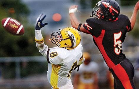 Flathead's Beau Watkins breaks up a pass intended for Helena's Corey Peterson during the first half of Flathead's game Friday night at Legends Stadium. Chris Jordan/Daily Inter Lake