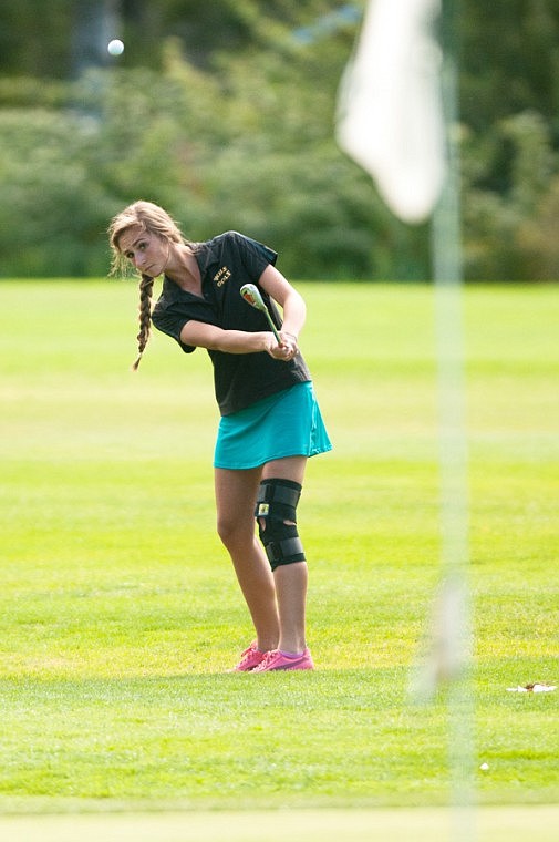 <p>Patrick Cote/Daily Inter Lake Whitefish junior Erin Tabish chips onto the ninth hole of the Cameron 9 Thursday afternoon during the Valley Quad golf tournament at Buffalo Hill Golf Club. Thursday, Sept. 6, 2012 in Kalispell, Montana.</p>