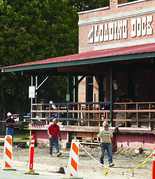 <p>Construction workers work on The Loading Dock renovation project on the corner of Center Street and First Avenue East. The historic building is being renovated for new businesses, including Brannigan's Pub and Brix Bottleshop.</p>