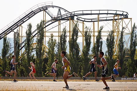 &lt;p&gt;Silverwood Themes Park's Corkscrew roller coaster towers in the background as area runners pass in front Saturday during the first lap of the high school varsity boys Coaster Cross cross country event.&lt;/p&gt;