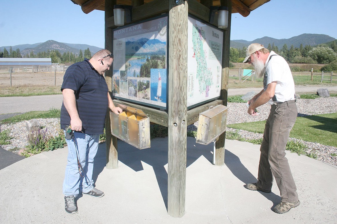 &lt;p&gt;John Cheesman, left, and Glenn Koepke refill brochures at the St. Regis Visitor Information Center.&lt;/p&gt;