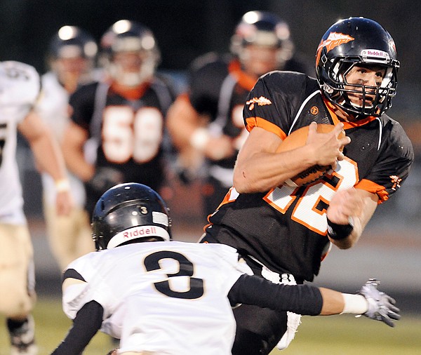 Flathead senior quarterback Mike VanArendonk (12) scrambles on a quarterback keeper during the game against Billings Friday in Kalispell.