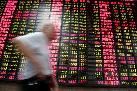 &lt;p&gt;An investor walks past the stock price monitor at a private securities company Thursday, in Shanghai, China. Chinese shares fell Thursday on fears of possible new government curbs on real estate as investors waited for monthly economic data.&lt;/p&gt;