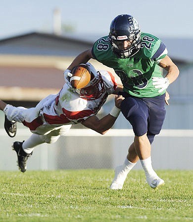 <p>Glacier running back Logan Jones breaks a tackle during a long run in the first quarter of the Wolpack's rout of the Bozeman Hawks at Legends Stadium Friday. (Aaric Bryan/Daily Inter Lake)</p>