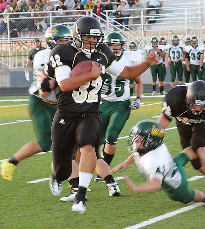 Damien Delarosa, 32, of Royal High School, breaks through the left side of the Quincy defensive line en route to a 100-yard rushing night.