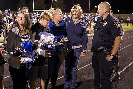 &lt;p&gt;From left to right, Fallen Coeur d&#146;Alene Police Sgt. Greg Moore&#146;s wife Lindy Moore, son Dylon Moore and Jen Brumley are given Lake City High School memorabilia and gifts from the school during a special tribute to Sgt. Moore on Friday, Sept. 11, 2015, at Lake City High School. Lake City High School Principal Deanne Clifford is pictured second from the right. More than $3,800 was donated to the Moore family.&lt;/p&gt;