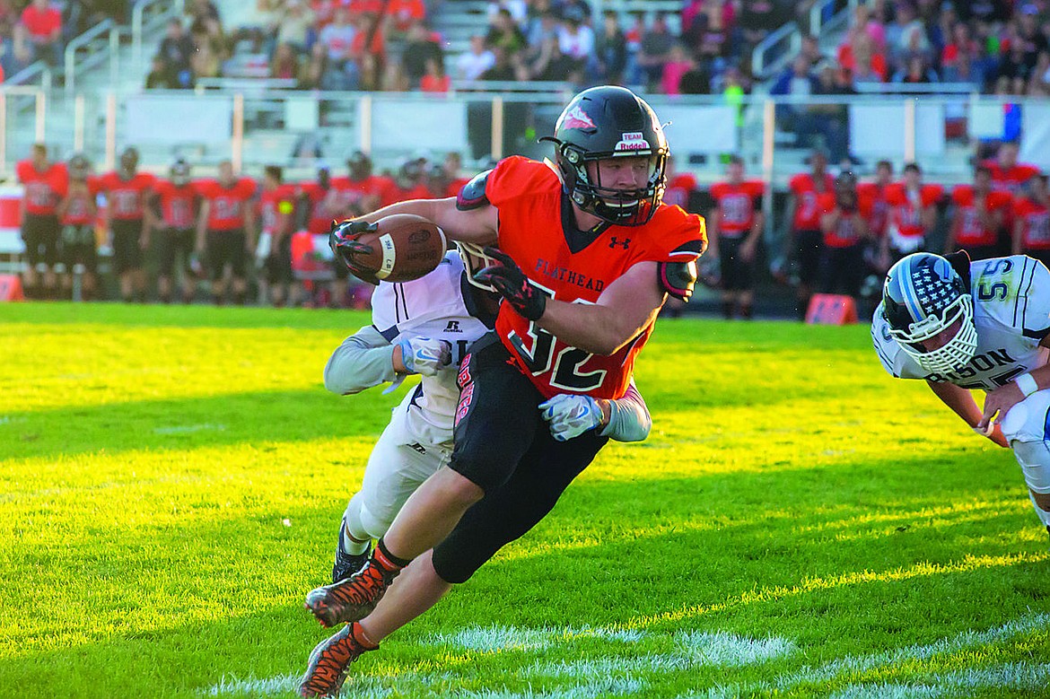 &lt;p&gt;Flathead senior running back Josh McCracken (32) carries a Great Falls defender with him on this first-half run Friday night at Legends Stadium. Flathead improved to 2-1 on the Class AA football season with a 41-12 victory in its home opener. (Kat Gebauer photos for the Daily Inter Lake)&lt;/p&gt;