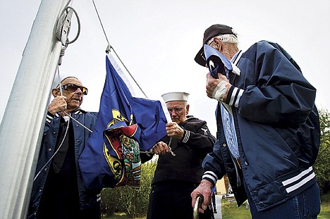 &lt;p&gt;Navy veterans Al Sweetman, left, Gene Cooper, and Charles Lish, right, prepare to raise the Idaho state flag Saturday during a ceremony marking the 24th Navy reunion at Farragut State Park near Bayview. The even drew nearly 100 to the former Navy base.&lt;/p&gt;