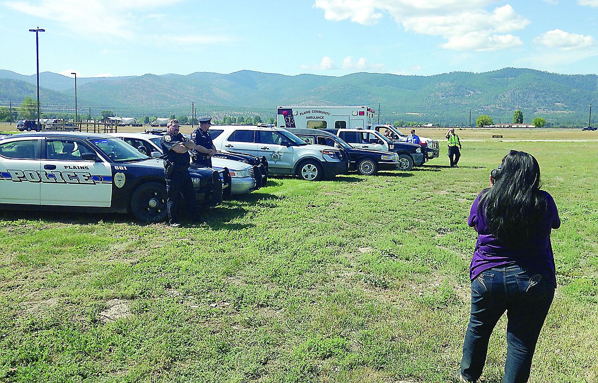 &lt;p&gt;A photographer takes pictures of local law enforcement officials as part of a billboard campaign that will launch in October.&lt;/p&gt;