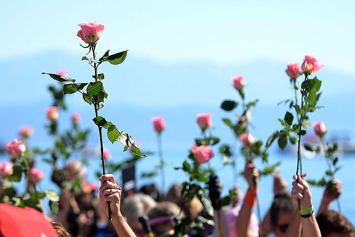 &lt;p&gt;The Portland Phoenix and the St. Paul Dragon Divas, two teams representing breast cancer awareness at the Dragon Boat Festival, were given pink roses during the rose ceremony at 12 p.m. Both teams raised their roses to salute those lost to breast cancer before dropping them in the water at the end of the ceremony. (Seaborn Larson/Daily Inter Lake)&lt;/p&gt;