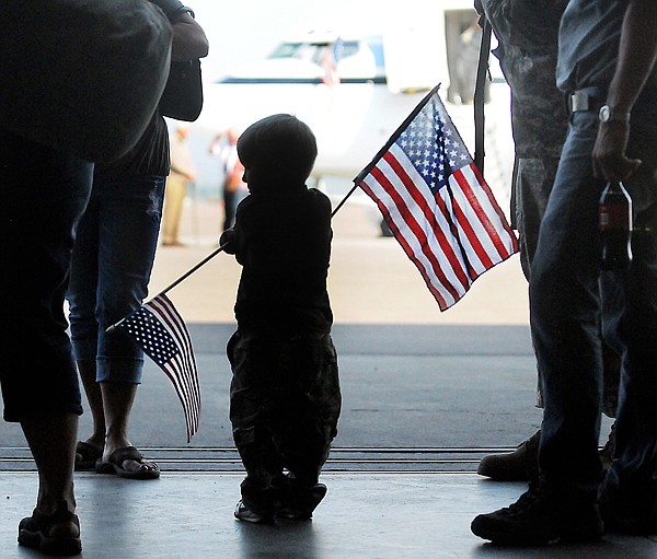 &lt;p&gt;Bransen Holzer, 3, of Libby waves flags at the home coming of
his father Staff Sgt. Brandon Holzer on Friday afternoon at Glacier
Park International Airport.&lt;/p&gt;