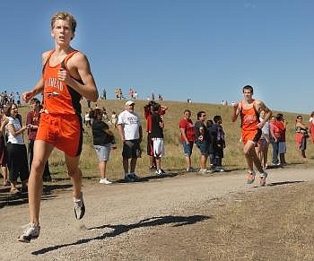 Flathead cross country runner Leif Castren (left) looks ahead to teammate and race leader Zach Perrin (not pictured) as he turns into the final stretch with Jesse Bennett on his heels during the Flathead Invitational at Kidsports Complex on Saturday. The Flathead boys finished just shy of a perfect score with 16 points. Allison Money/Daily Inter Lake