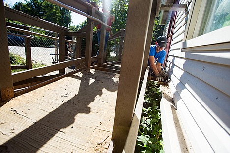 &lt;p&gt;Tony Cline, with Avista Utilities, disassembles a portion of an old stairs and ramp to make improvements on the approach at the men's shelter as part of the Day of Caring volunteer event.&lt;/p&gt;