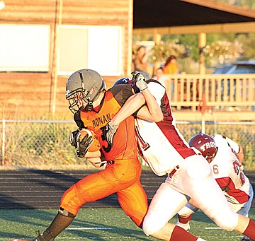 &lt;p class=&quot;p1&quot;&gt;Dallas Jore shrugs off a Trojan defender as he crosses into the end zone for a score on Friday.&lt;/p&gt;