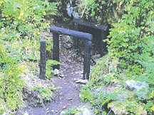 The entrance to the Nicholson adit. Pulaski and his 45 men hid in the exploratory mine, which measured no more than 200 feet deep. The wooden beams outside were recreated by a local Wallace artist.