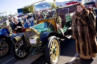 <p>Wearing a vintage fur coat, Garrie Zordich of Boring, Ore. stands next to her 1910 Velie "D" Touring horseless carriage before the start of the second day of the 19th Annual Regional "Panhandle Scramble" Tour. More than 100 horseless carriage enthusiasts drive their vintage cars that are at least 100-years-old through St. Maries, Hayden Lake, Coeur d'Alene and Bayview in the annual tour. The Skagit-Snohomish Region of the Horseless Carriage Club of America organizes the annual event.</p>