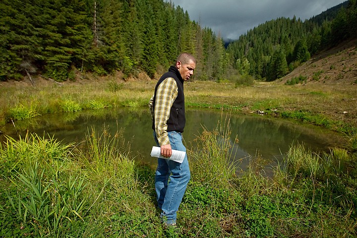 &lt;p&gt;Jeff Johnson, a U.S. Forestry Service project manager for the Silver Crescent Mine clean-up and restoration effort, walks by one of the ponds that has flourished with new aquatic life and vegetation since the project began in 1999.&lt;/p&gt;