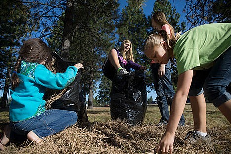 &lt;p&gt;From left: Millie Johnson, 9,&#160;Megan Tanner, 14, Rachael Adams, 15, and Melody Loutzenhiser, 12, of the Lakeland Second Ward of the Church of Jesus Christ of Latter-Day Saint help shovel pine needles into trash bags at the Children&#146;s Village on Saturday morning.&lt;/p&gt;