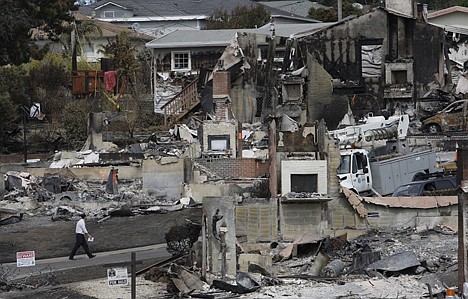 &lt;p&gt;A man walks past the remains of homes damaged from a fire caused by an explosion in a mostly residential area in San Bruno, Calif., Monday. The explosion prompted California regulators to order the utility, Pacific Gas and Electric, to survey all its natural gas lines in the state in hopes of heading off another disaster.&lt;/p&gt;